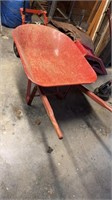 Red metal wheelbarrow, with a rubber tire that