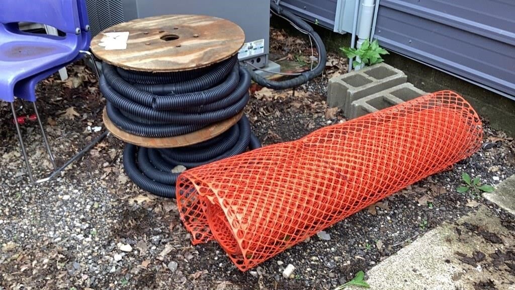 Orange fence and spools of tile