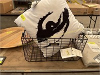 Black metal basket with white and black pillow