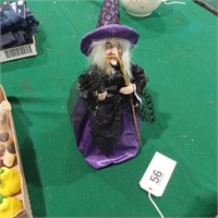 Witch with cane and spells book