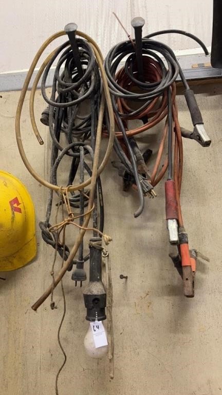 Lot of jumper cables, lights, and work hat etc