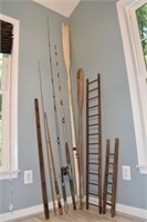 Lot: 3 fishing poles and Penn 209 reel, 2 oars, 2