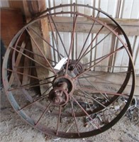 (2) Antique steel wheels. Measures 44" diameter.