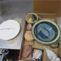 Clock, stones, stoneware bowl, brass bell,