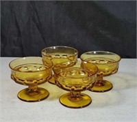 4 amber colored dessert dishes