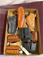 Flat of holsters and ammo holders