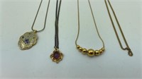 Four Gold Toned Necklaces Two with Pendants