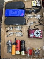 Eyeglasses, cigarette lighters, Nikon camera,