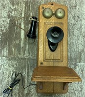 Vintage wall hanging dial phone in wood cabinet br