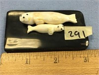 A mom and baby seal carved out of fossilized ivory