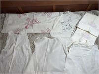Vintage baby clothes and tub of vintage linens