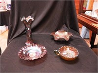 Four pieces of carnival glass: two are blue,