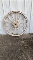 White wooden wagon wheel with metal rim