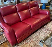 Red leather reclining sofa with nail head trim