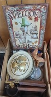 box of decorative items with sign