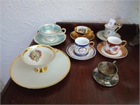 7 teacups and saucers of various sizes and