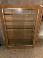 Heavy display cabinet with sharp edged glass in