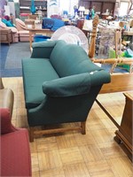 Forest green upholstered camelback sofa, 84" long