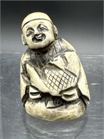 ANTIQUE CARVED BONE SIGNED MAN WITH FISH NETSUKE