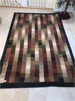 MULTICOLORED RUG, 62" X 96" IN GOOD CONDITION