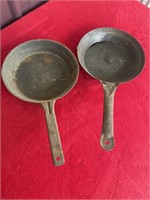 Two aluminum camping skillets