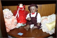 GROUPING: 4 PORCELAIN DOLLS 1 IS HAPPY HOLIDAY