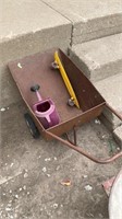 Wheel barrow, watering can, skateboard