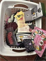 clothes basket ful of magazines. gloves, tier