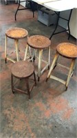 Four Small Rusty Metal Stools