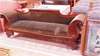 Empire mahogany sofa with rolled arms,