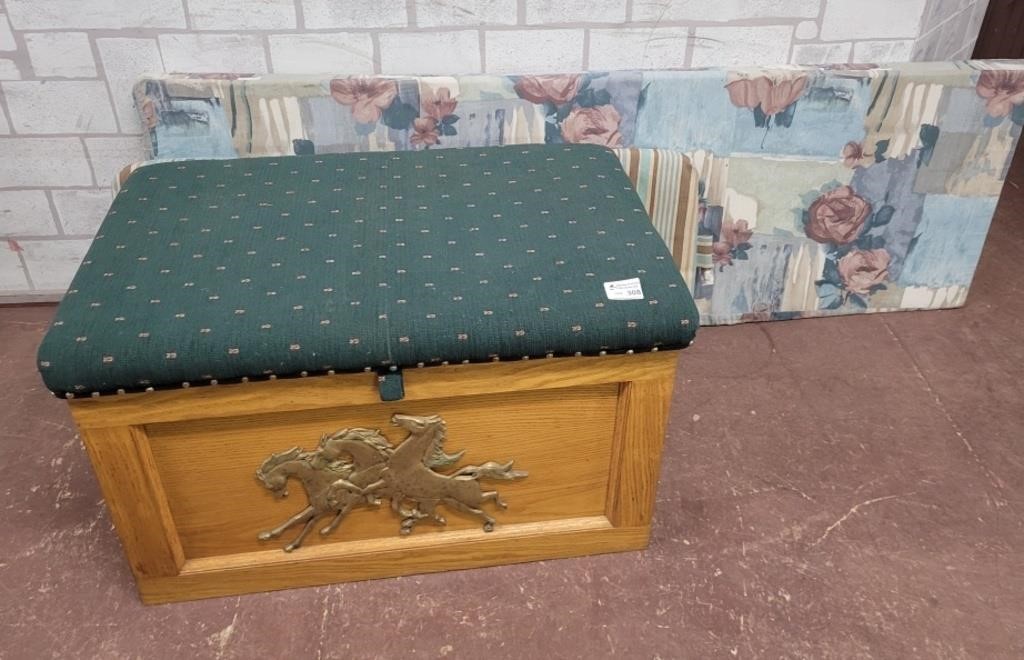 Wood trunk with horses on the front. With cussions
