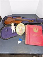 Antique violin, porcelain doll, etiquette book