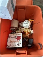 Orange tote filled with a variety of fall decor