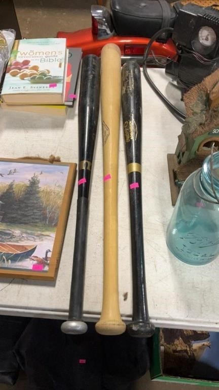 Two wooden bats and regular baseball bat