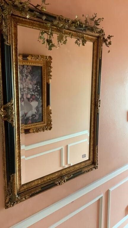 Gold framed beveled wall mirror