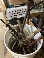 assorted tools and objects in 5 gallon pail