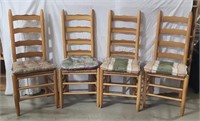 Ladderback caned dining chairs with cushions.