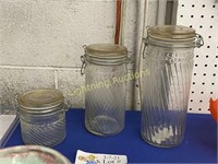 THREE GLASS CANISTERS WITH RUBBER SEAL LIDS