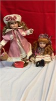 2 dolls/ girl in pink coat//sitting girl