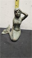 Cast iron mermaid.