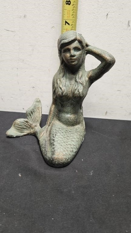 Cast iron mermaid.