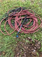 water hose and sprayer, electrical cord, red hose