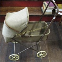 Vintage cloth and metal doll buggy