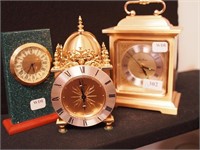Three decorative clocks: carriage style, one set