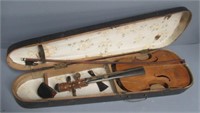 Antique violin in wood coffin case.
