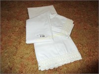 Pair of white pillow cases with tatting on hem