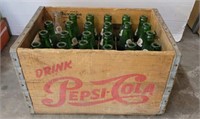 GROUP OF BOTTLES IN PEPSI CRATE