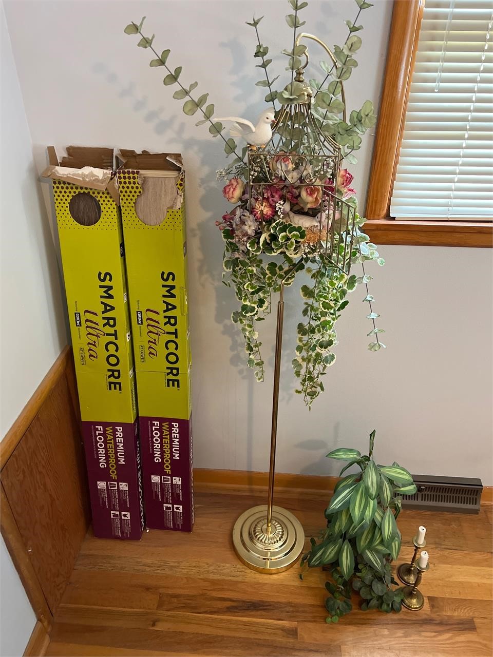 Two partial boxes of flooring and some brass items