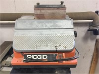 Rigid oscillating edge belt spindle sander