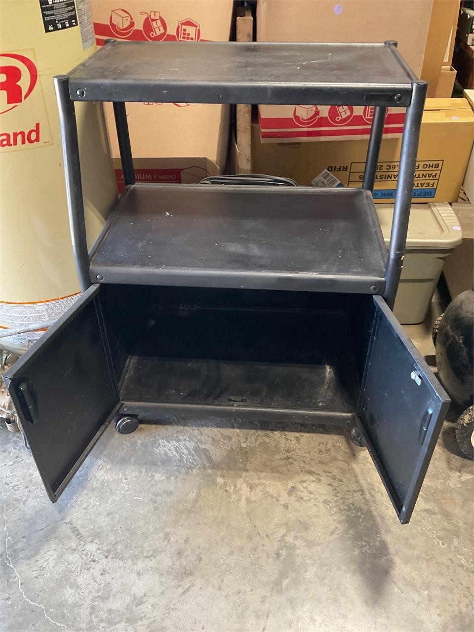 Metal table on wheels with electric plug